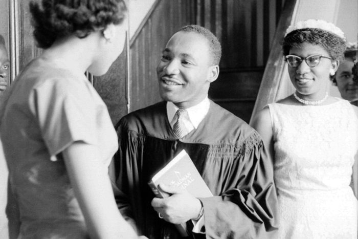 Martin Luther King Jr. speaking to someone after church. 