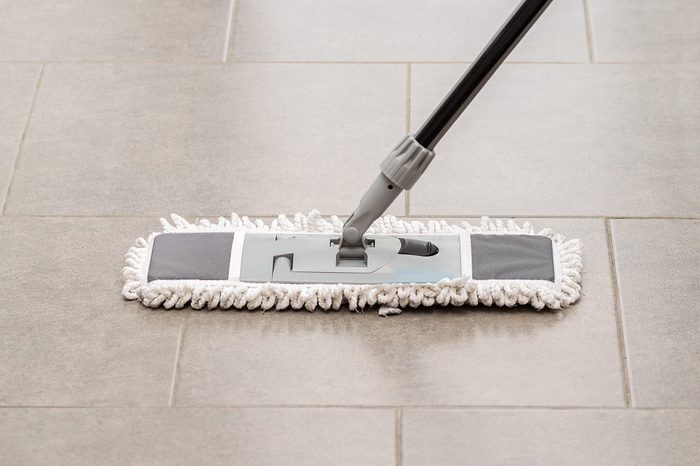 Cleaning gear mopping a living room floor with tile