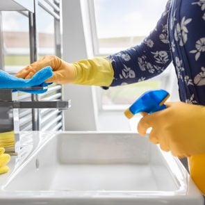 Cleaning sink and faucet with antibacterial detergent, corona virus prevention
