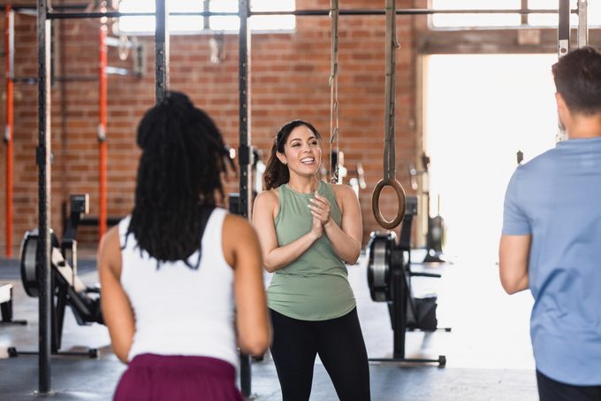 Fitness instructor talks with exercise class