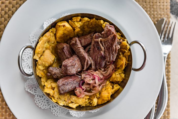 Puerto Rican beef and plantains Mofongo meat dish. Puerto Rico food culture. Mofongo is a typical meal with fried cooking bananas as its main ingredient. Plantains are picked, fried then mashed.