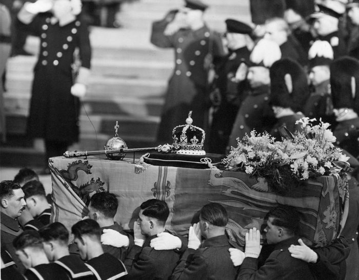 The coffin of George VI, draped with the royal standard being carried by soldiers at his funeral, 15th February 1952. On the top are symbols of royalty, a crown, sceptre and orb. (Photo by George W. Hales/Fox Photos/Hulton Archive/Getty Images)
