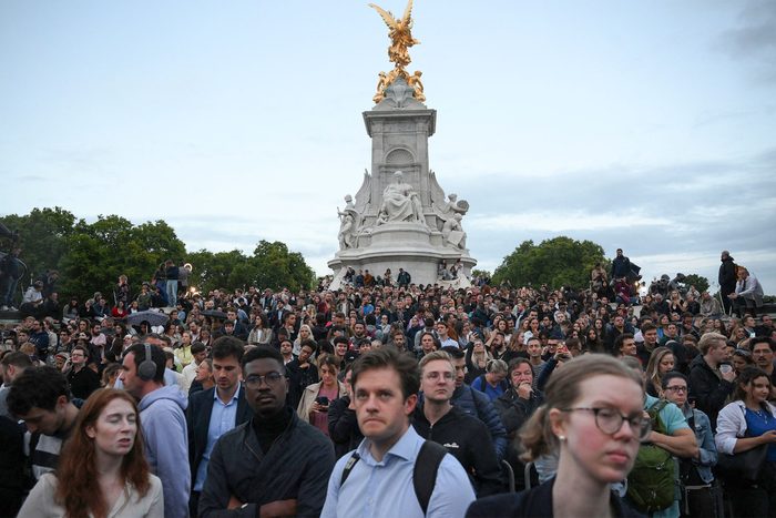 People gather outside Buckingham Palace in central London after it was announced that Queen Elizabeth II has died, in central London on September 8, 2022.