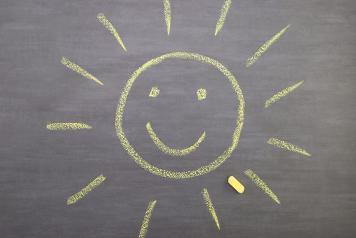 smiling Sun Drawn with chalk On a Blackboard