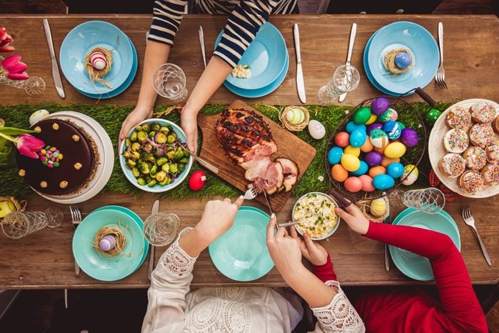 Overhead view on decorated Easter table with family around