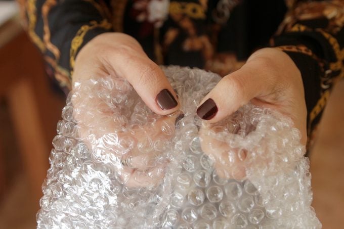 Hands Pupping Bubbles On Bubble Wrap
