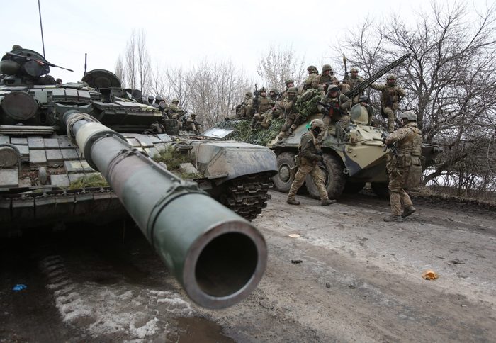 Ukrainian servicemen with tanks get ready to repel an attack in Ukraine's Lugansk region on February 24, 2022.