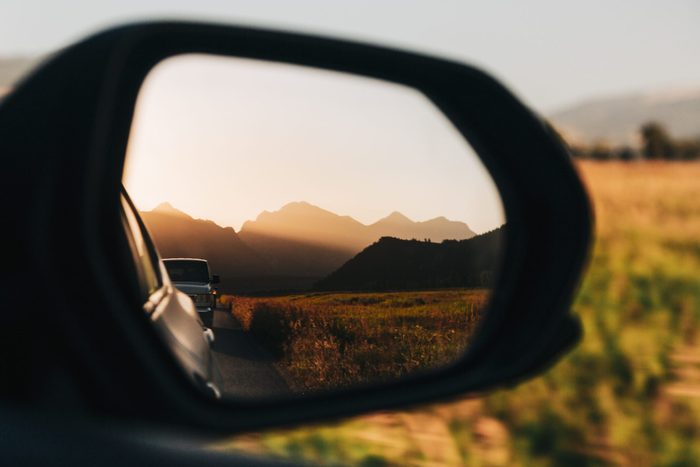 View of mountains reflected in side-view mirror of car at sunset,Teton County,Wyoming,United States,USA