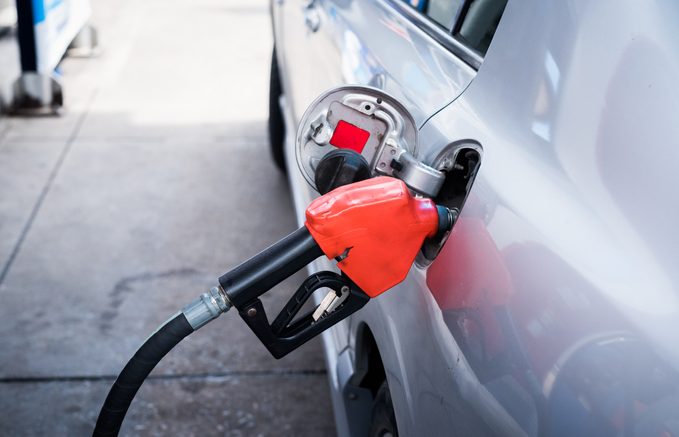 Close-up of car refueling at a gas station with regular gas