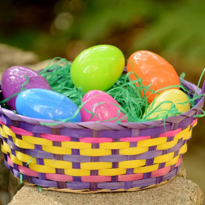 colorful easter basket with plastic eggs