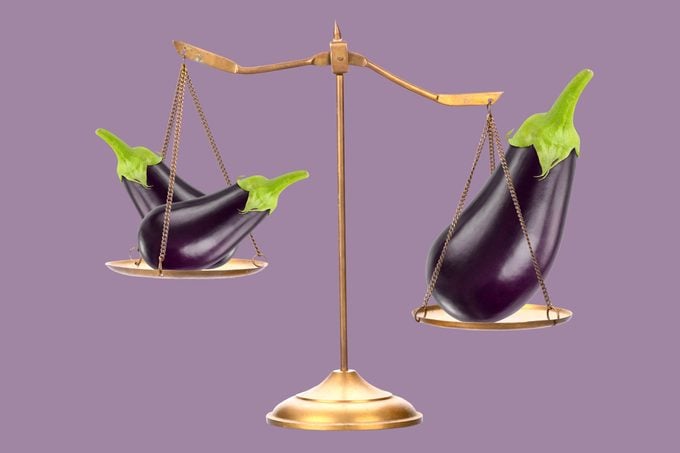 scale with two eggplants on one side and one larger eggplant on the other
