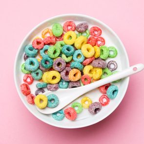 bowl of colorful cereal on a pink background