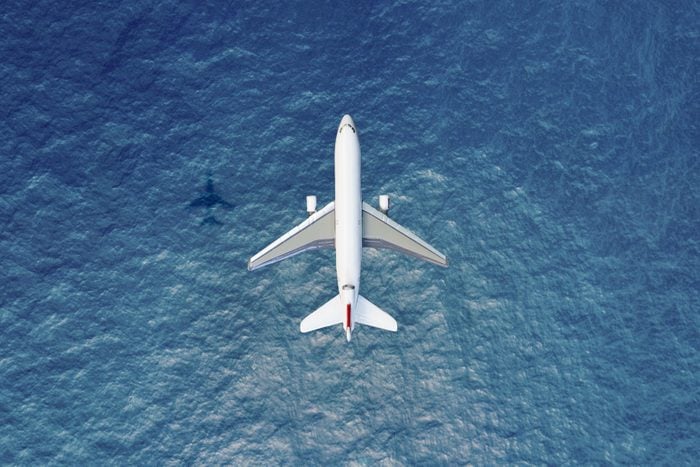 overhead view of an Airplane flies over water
