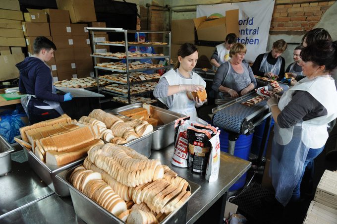 Staff members of a local restaurant together with the organization World Central Kitchen work to prepare sandwiches for refugees and Ukrainian territorial troops.