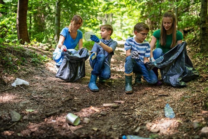 Family cleaning trash in the forest