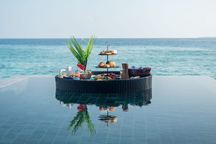 Floating breakfast on infinity pool in luxury hotel