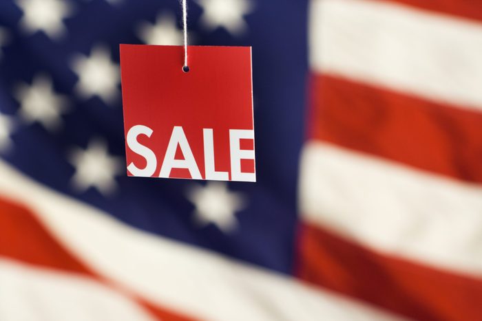 Sale Tag hanging over an american flag for memorial day furniture sales