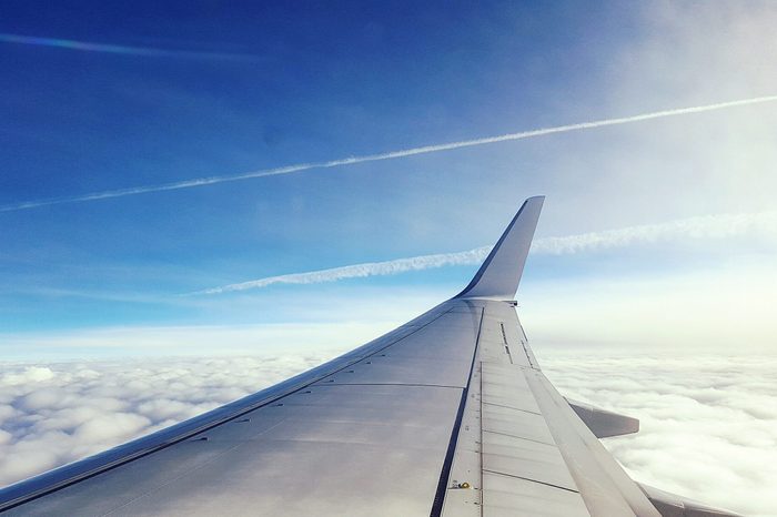 Airplane wing Flying Over Clouds