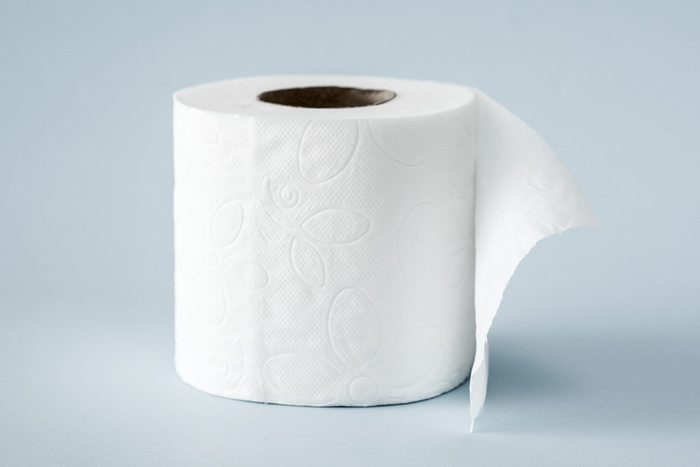 White roll toilet paper on the light blue background
