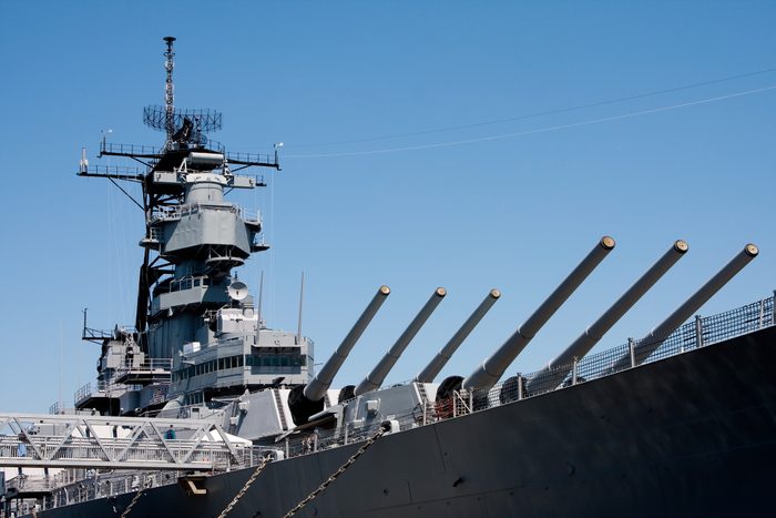 Turrets on navy battle ship with blue sky background