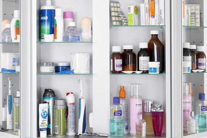 Filled Bathroom cabinet with medicine and other supplies