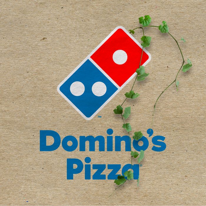 Domino's logo with vines growing out on a kraft paper background