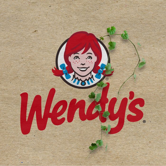 Wendy's logo with vines growing out on a kraft paper background