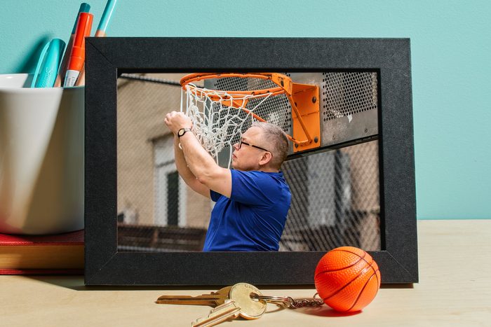 Photo of a man changing basketball net