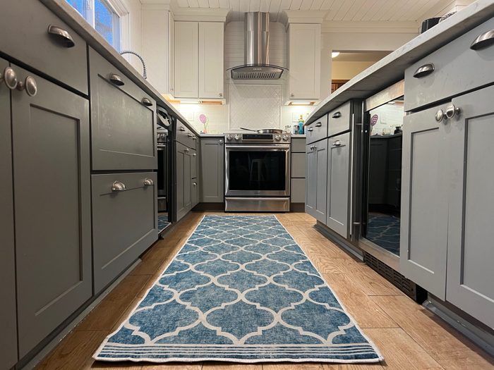 Blue patterned runner rug in a modern grey and white kitchen