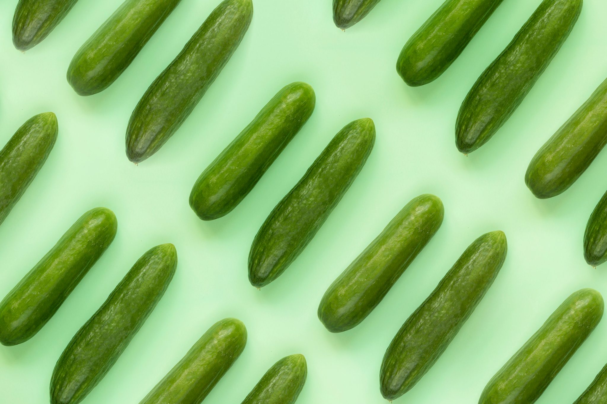 Cucumbers on green background