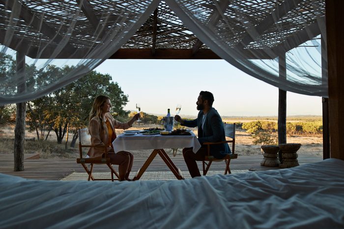 Couple having private romantic dinner in luxury cabin in South Africa
