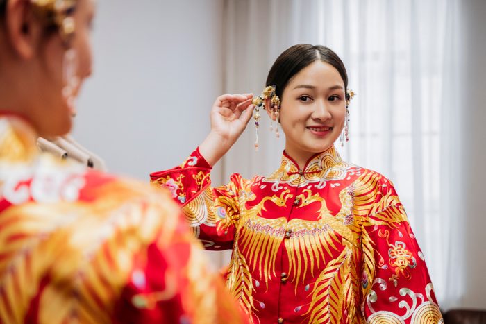 Reflection of Chinese bride and traditional hair accessories in red dress