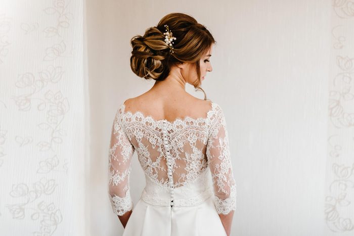 bride in white dress with fancy hair