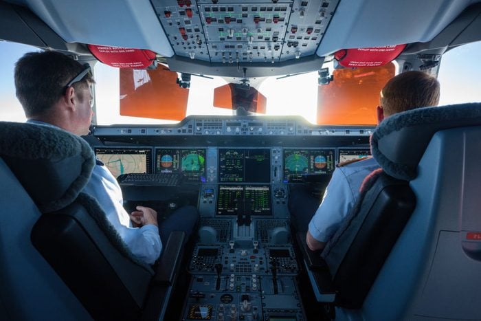 pilots in cockpit of an airplane