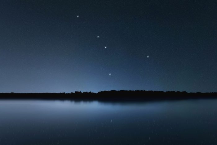 Cancer star constellation in the Night sky over a lake