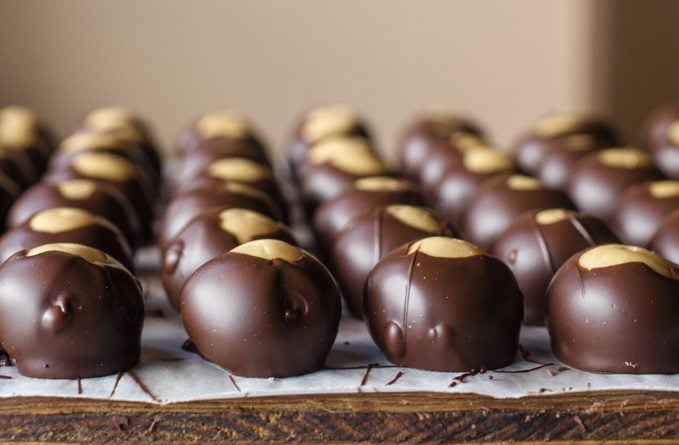 rows of neatly lined up chocolate peanut butter balls
