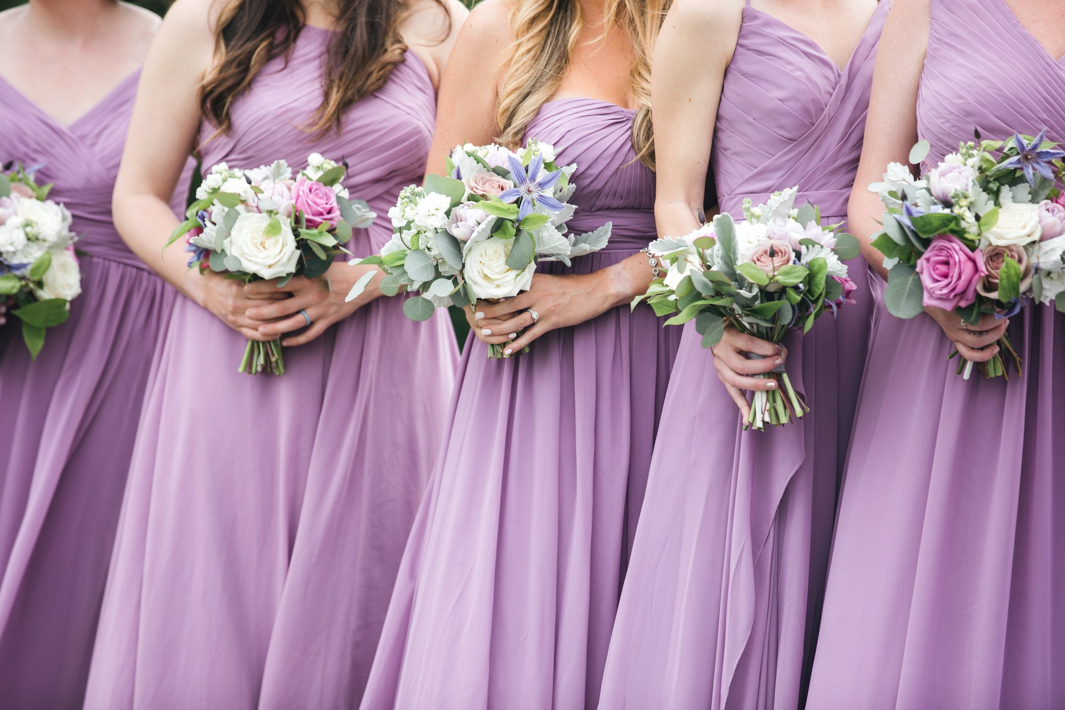 Close up of bridal party with floral bouquets