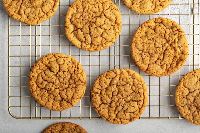 Thin and chewy molasses cookies on a baking rack