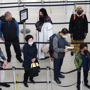 people wait in line at JFK airport as Florida Judge Overturns Cdc's Travel Mask Mandate
