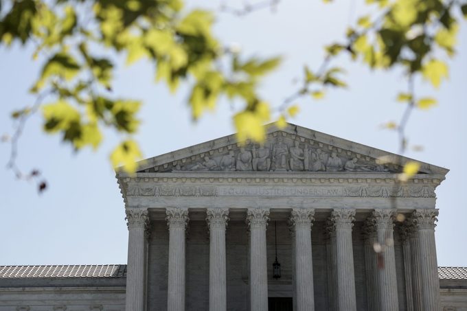 A view of the U.S. Supreme Court Building on May 09, 2022 in Washington, DC through blurred tree branches in the foreground