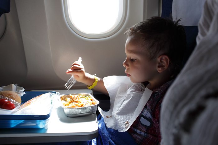Child has lunch on airplane