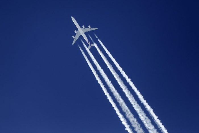 white lines or vapor trails behind a Airbus A340