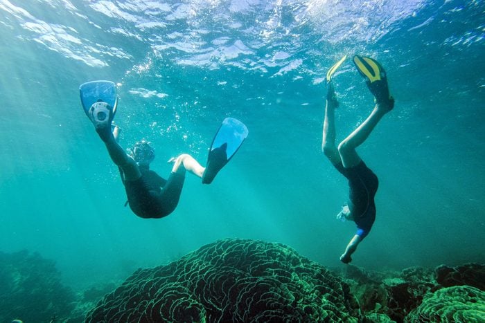 Boy and girl swimming underwater, Exmouth, Western Australia, Australia