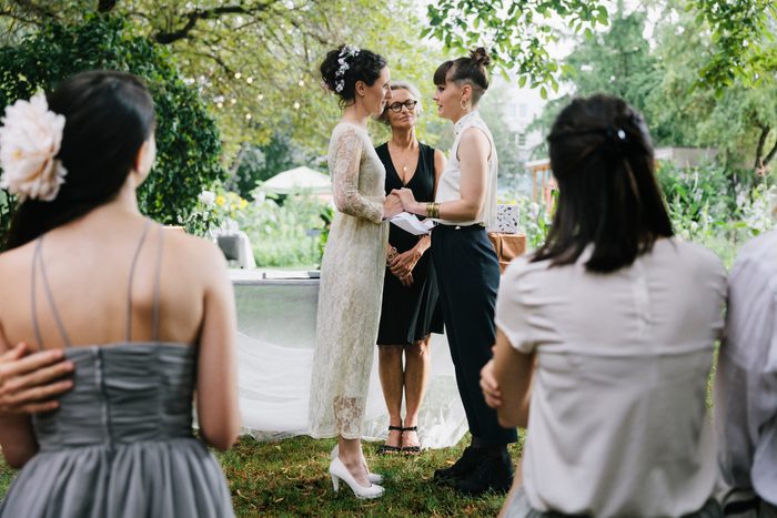 Lesbian couple standing at the altar