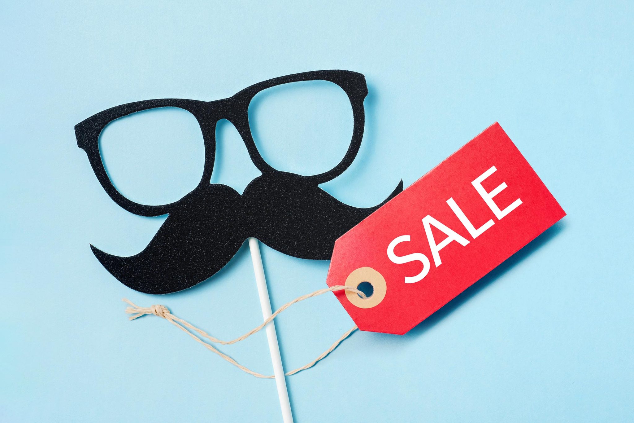 Fathers Day photo prop with glasses and a mustache with a red tag that reads "SALE" on blue background