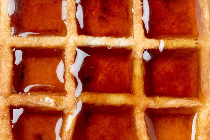 Belgian waffle with syrup macro full frame