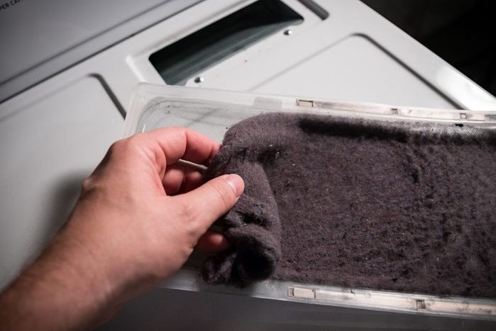 Hand cleaning clothes dryer lint trap