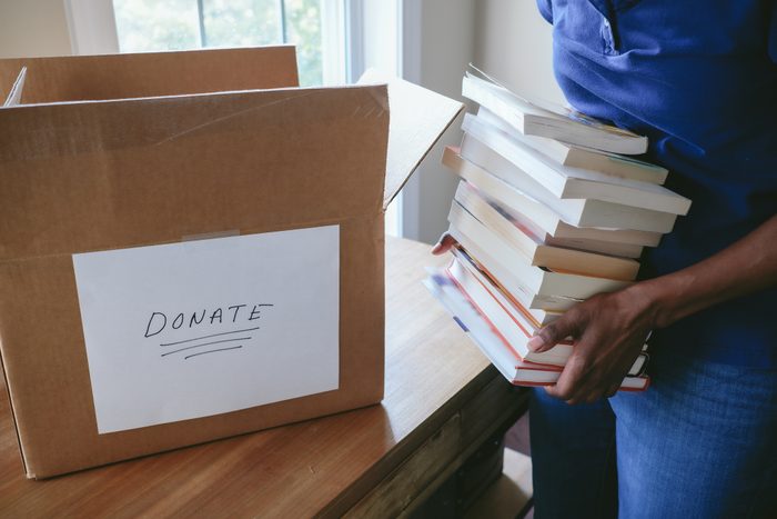 Woman Packs Books for Donation