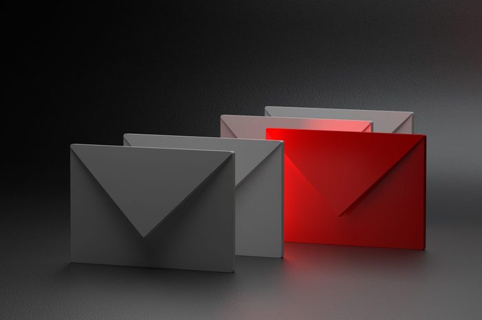 four email envelopes, one is red for spoofing