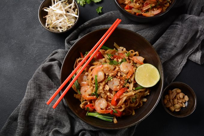 Thai Fried Noodles "Pad Thai" with shrimps and vegetables in a bowl